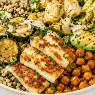 Goddess Grain Bowl: Fried Zucchini & Halloumi - Discover the ultimate Greek Goddess Grain Bowl! Packed with crispy zucchini, fried halloumi, toasted seeds, and