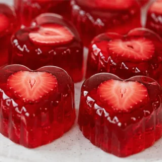 Jiggly Strawberry Jello Hearts - Strawberry jello: craft these adorable, jiggly heart-shaped desserts with ease. A simple, two-ingredient vegan recipe perfect f