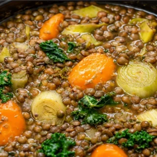 Hearty Vegan Lentil Soup - Make this hearty Vegan Lentil Soup with whole lentils, carrots, and kale. A delicious, healthy, and easy plant-based meal ready in un